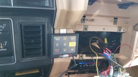 1985 Ford Bronco - Aftermarket digital gauge installed in the dashboard of a vehicle, showing engine parameters.