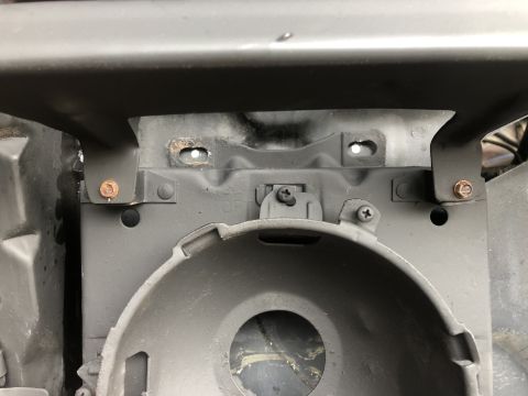 1978 Ford Bronco - This image shows the internal mounting hardware for a vehicle's headlight assembly.