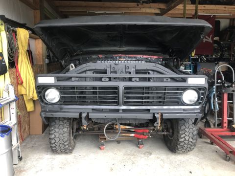 1978 Ford Bronco - Front view of a 1978 Ford Bronco undergoing restoration, hood is open.