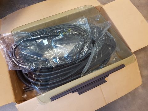 1978 Ford Bronco - New window seals and trim are packed inside a cardboard box, ready for installation.