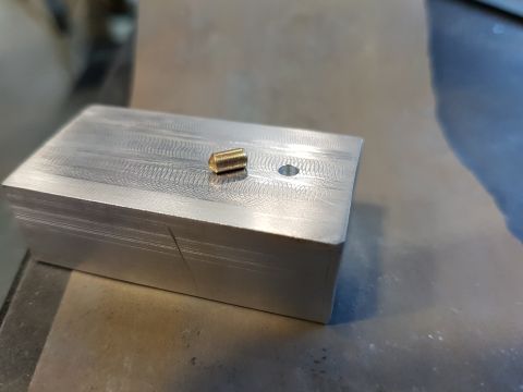 1978 Ford Bronco - A close-up shows a metal block with a brass fitting and a drilled hole, with a website logo visible.