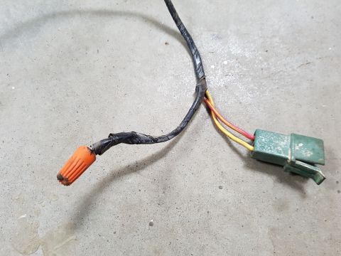 1978 Ford Bronco - Close-up of a wiring harness an orange wire nut and a green electrical connector, likely a replacement part.
