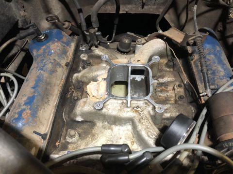 1980 Ford Bronco - Close-up view of an engine's intake manifold, revealing its internal components and condition.