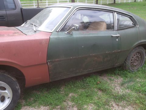1972 Ford Maverick - This 1972 Ford Maverick shows a side profile with a red front fender and green rear body panels.