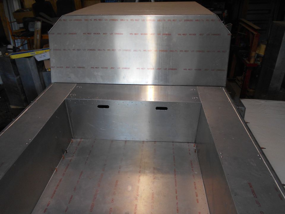 Aluminum truck bed interior with visible text on side panels