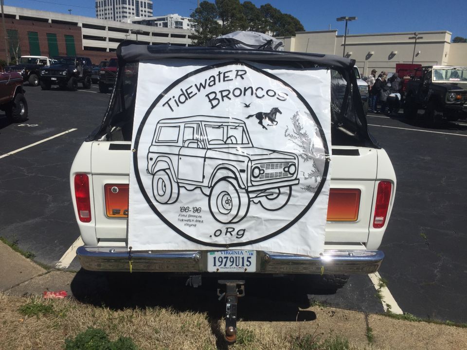 1979 Ford Bronco rear view, white with black soft top, displaying a banner for Tidewater Broncos. License plate reads 1979U15
