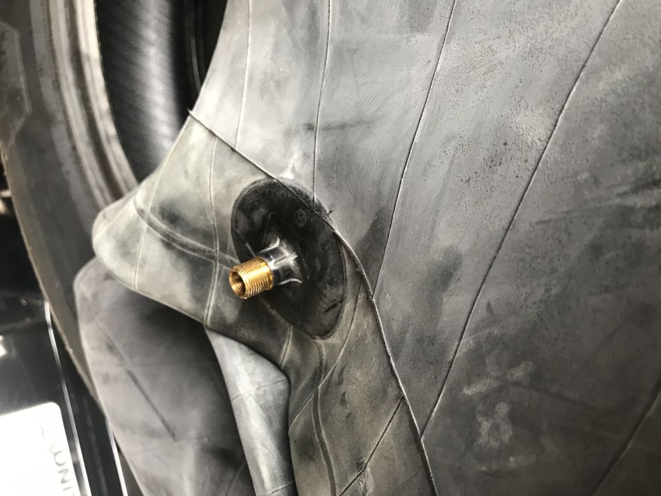 Inner tube with brass valve stem, close-up view