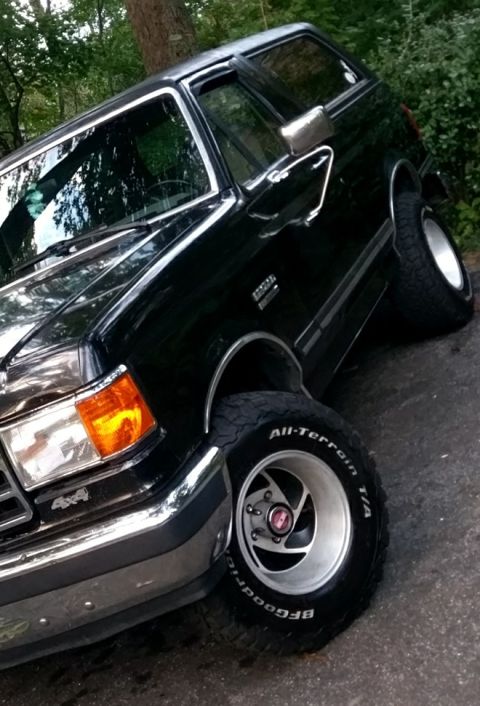 1988 Ford Bronco - 1988 Ford Bronco shown from a 3/4 front angle, aftermarket wheels and tires.