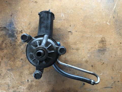 1978 Ford Bronco - This is a close-up view of a power steering pump, likely removed from a vehicle for repair or replacement.