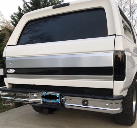 1995 Ford Bronco - Rear view of a white 1995 Ford Bronco, a chrome bumper, tinted windows, and a license plate.