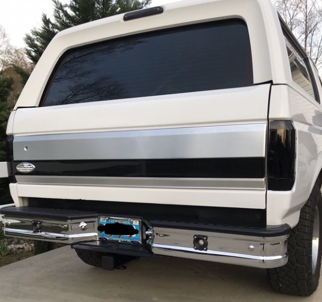 White 1995 Ford Bronco rear view with chrome bumper and tinted windows