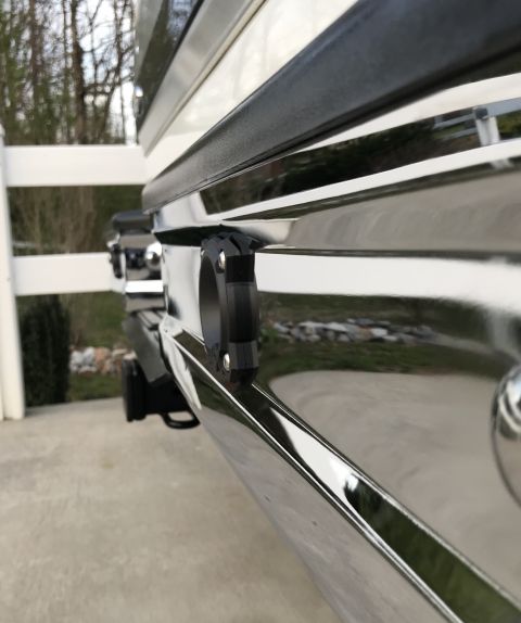 1995 Ford Bronco - Close-up of a chrome rear bumper a black tow hook and a Supermotors.net watermark.