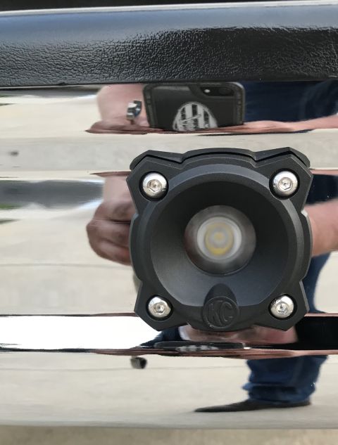 1995 Ford Bronco - An aftermarket LED light is attached to the chrome bumper of a vehicle. A phone is visible in the reflection.