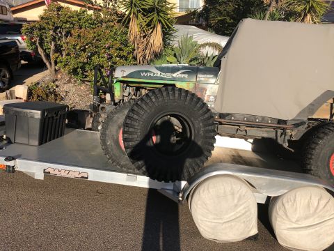 1992 Jeep Wrangler - This Jeep Wrangler is loaded onto a trailer, oversized tires and a soft top.