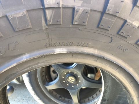 1992 Jeep Wrangler - A close-up view of a large off-road tire with visible tread detail and sidewall markings.