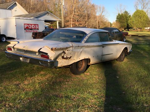 1960 Ford Starliner - This classic Ford coupe shows extensive damage to its rear quarter panel and trunk area.