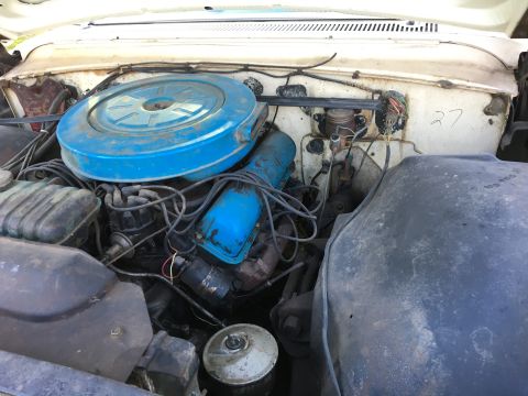 1960 Ford Starliner - Engine bay of a 1960 Ford Starliner, a blue air cleaner and valve covers.