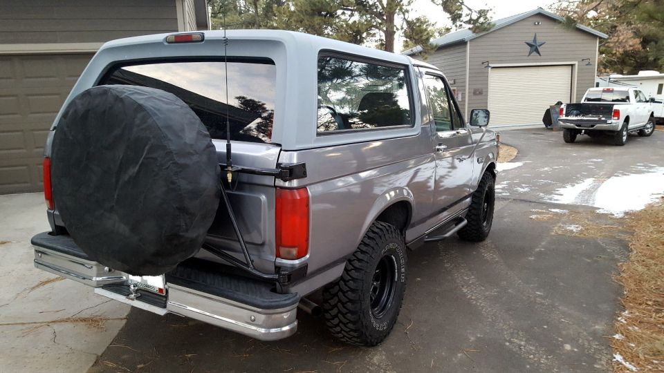 Gray 1995 Ford Bronco rear view with spare tire on back