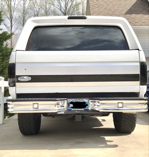 1995 Ford Bronco - Rear view of a 1995 Ford Bronco, showing its distinctive body style and chrome bumper.
