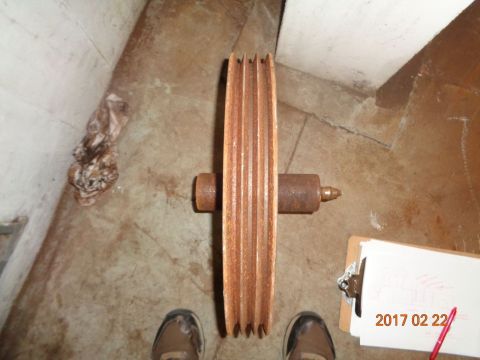 1965 Ford Mustang - A rusty pulley is shown in a workshop setting, with a clipboard and date stamp visible.