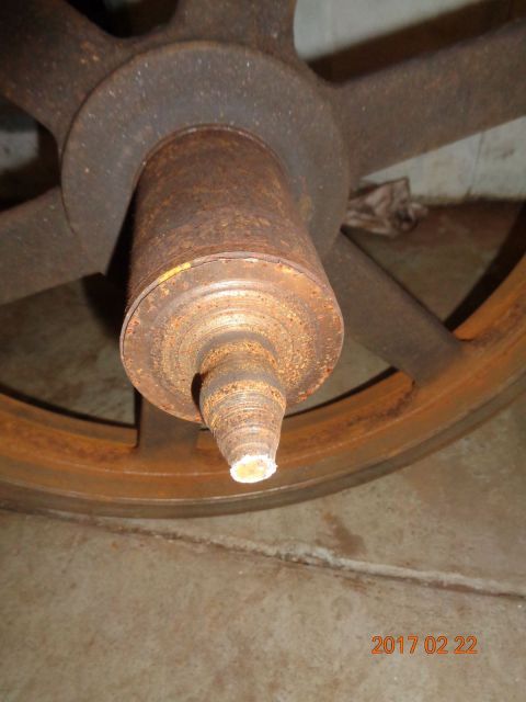 1965 Ford Mustang - Close-up of a heavily rusted wheel hub and spindle, with a date stamp visible in the lower right corner.