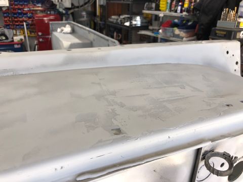1992 Jeep Wrangler - Jeep tub section undergoing bodywork, showing primer and some imperfections.