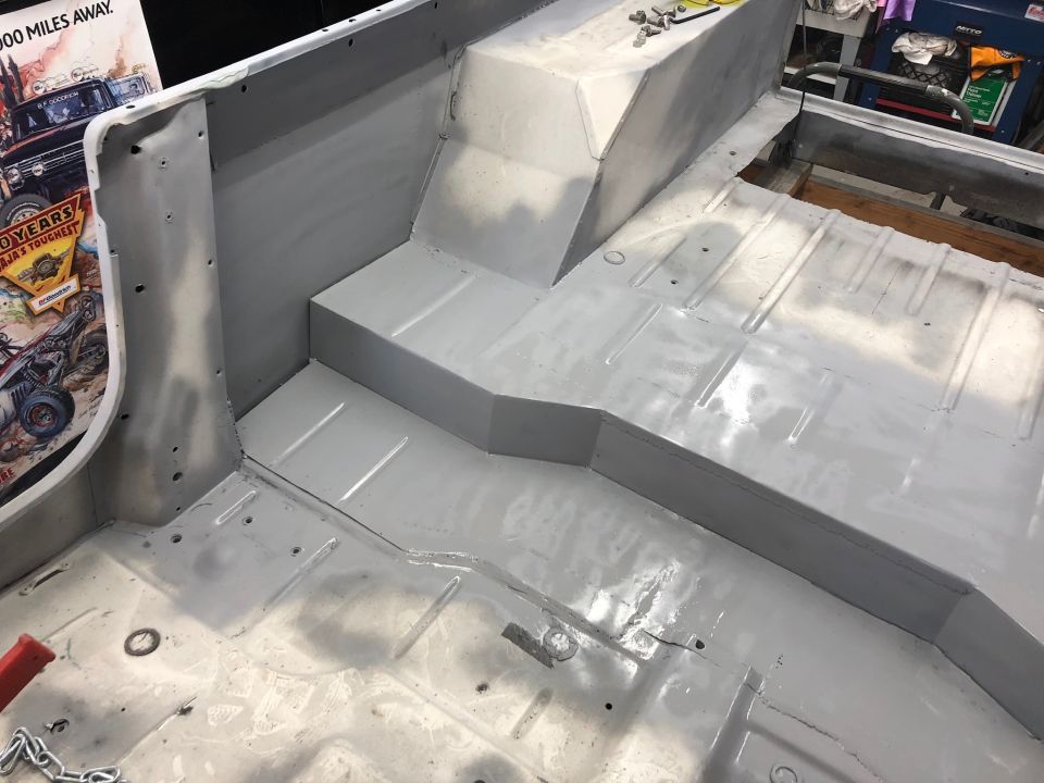 Interior floor of a Jeep CJ, looks like it's been prepped for paint or coating