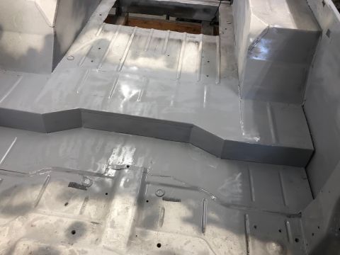 1992 Jeep Wrangler - The interior floor of a vehicle, likely undergoing restoration, is coated in gray paint.