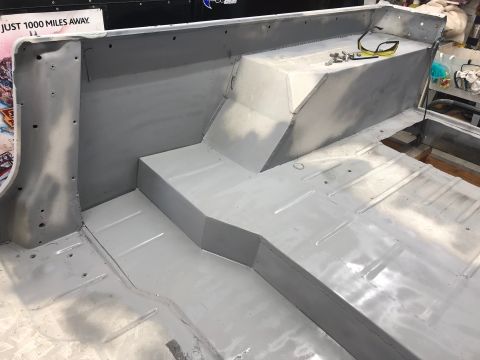 1992 Jeep Wrangler - The interior of a Jeep is shown after bodywork, with the floor and rear seating area prepped for further restoration.