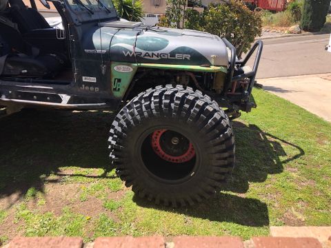 1992 Jeep Wrangler - Modified 1992 Jeep Wrangler shows off its massive off-road tires and custom wheels.