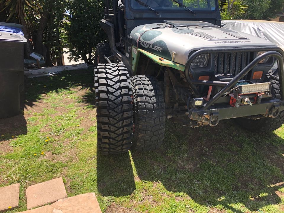 Jeep Wrangler showing off its large off-road tires, one wider than the other