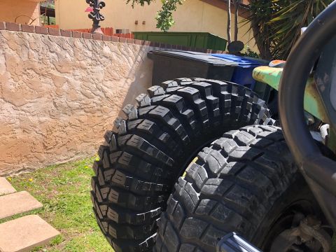 1992 Jeep Wrangler - Close-up view of aggressive off-road tires, suggesting off-road capability.