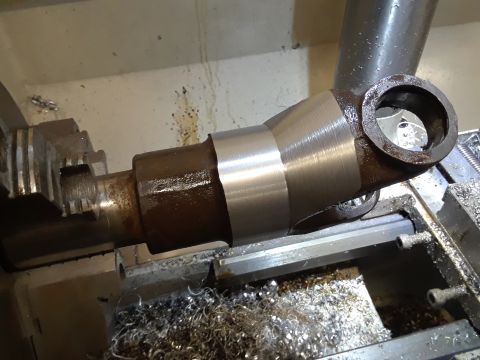 1985 Ford Bronco - Machining a metal component on a lathe, surrounded by metal shavings.