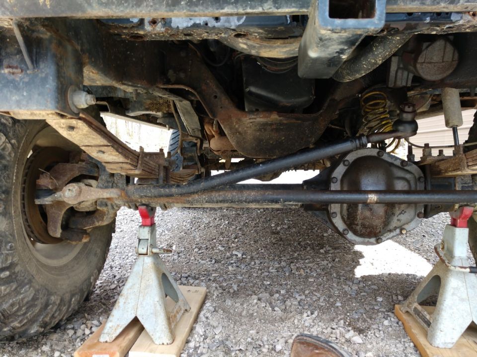 Undercarriage view of a Dana 60 axle on jack stands