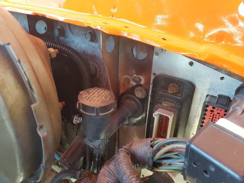1978 Ford Bronco - Close-up of engine bay components including wiring and brake fluid reservoir.