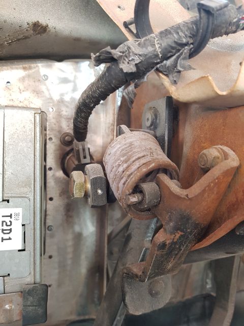 1978 Ford Bronco - Detail of the brake pedal assembly, showing a spring and electrical connections.