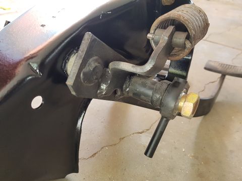 1978 Ford Bronco - This photo shows a close-up view of a vehicle's clutch pedal mechanism, including its spring and linkage components.