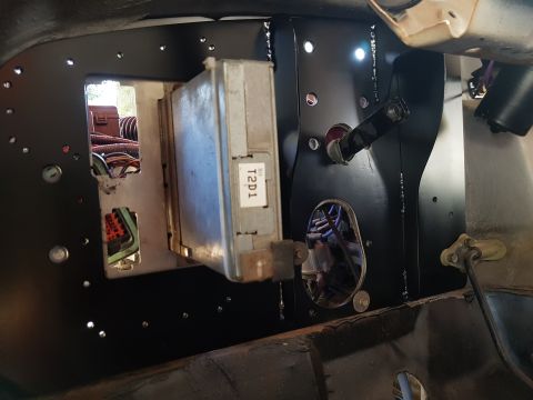 1978 Ford Bronco - Close-up of an engine control unit with a T2D1 label, mounted within a vehicle's interior.
