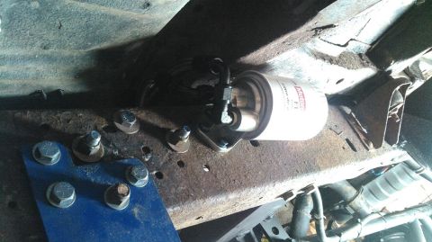 1978 Ford Bronco - Motorcraft fuel filter assembly attached to the vehicle's frame.