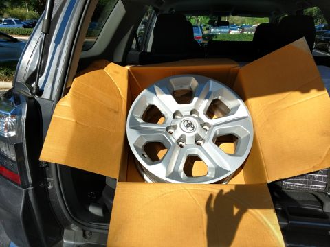 2018 Toyota 4Runner - A new Toyota 4Runner wheel is packed in a box within the trunk of a vehicle.