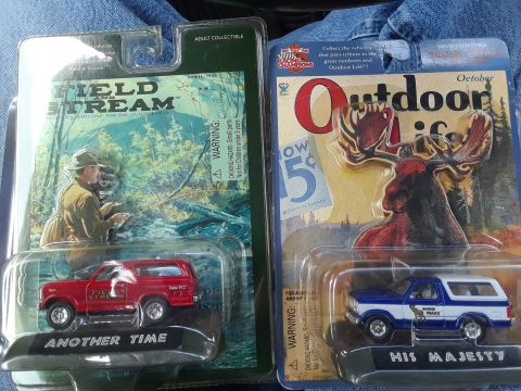 1994 Ford Bronco - Packaged toy trucks, one red and one blue and white, displayed for sale.