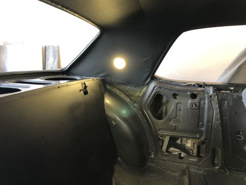1968 Mercury Cougar - The interior of a 1968 Mercury Cougar shows its bare metal construction and black headliner.