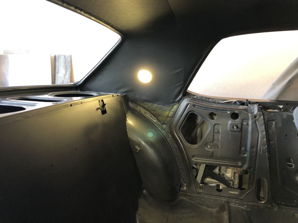 1968 Mercury Cougar interior showing bare metal door frame, black headliner with dome light, and rear quarter panel