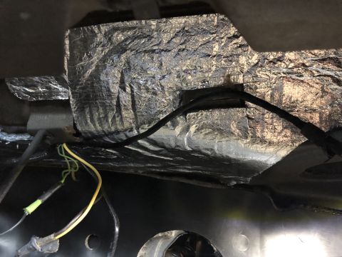 1968 Mercury Cougar - Exposed wiring and insulation are visible on the underside of a vehicle.
