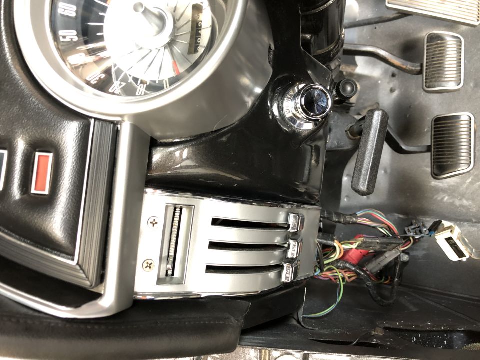 Dashboard of a 1968 Mercury Cougar, showing the instrument cluster, climate controls, and pedals