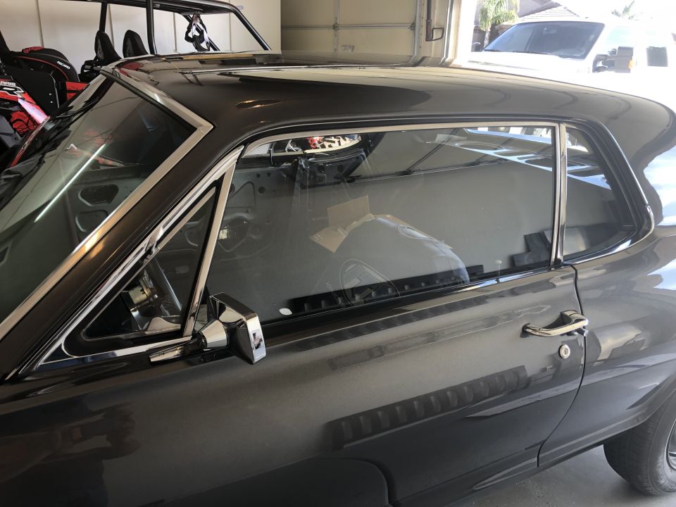 Dark gray 1968 Mercury Cougar coupe, side view, chrome trim, interior visible through windows