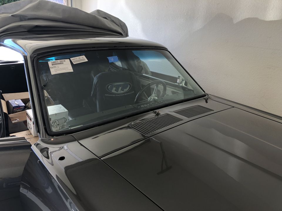 Interior view of a car with a steering wheel and dashboard
