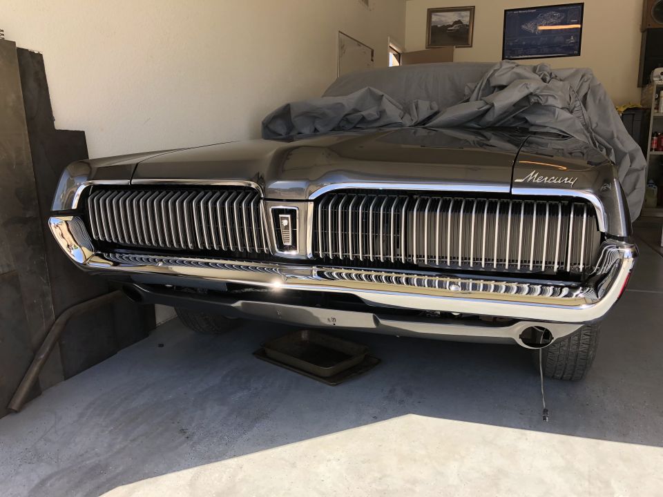 1968 Mercury Cougar front grille and bumper, chrome details, car cover partially on