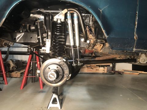 1979 Ford Bronco - The rear suspension system of a vehicle is shown elevated on jack stands for maintenance.