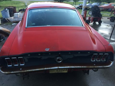 1967 Ford Mustang - Rear view of a red 1967 Ford Mustang showing its distinctive taillights and 'MUSTANG' badging.